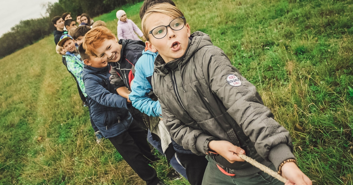 Children playing tug-of-war outside