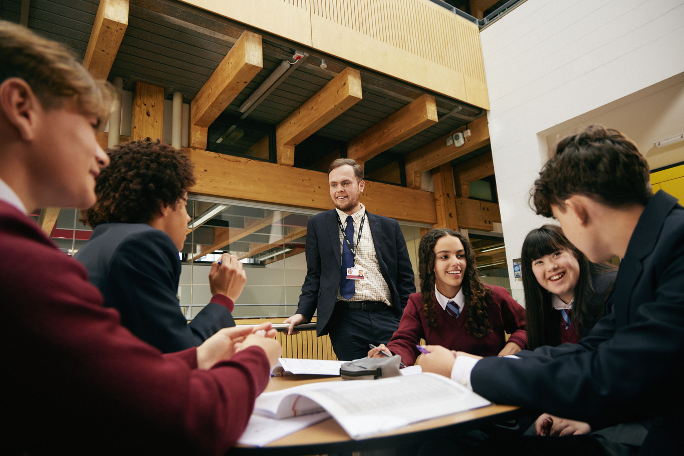 A teacher talking to students while they're working.