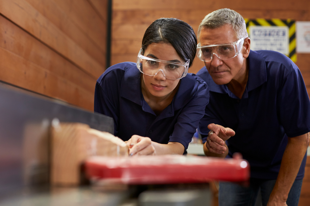 A teacher helping a student with work.